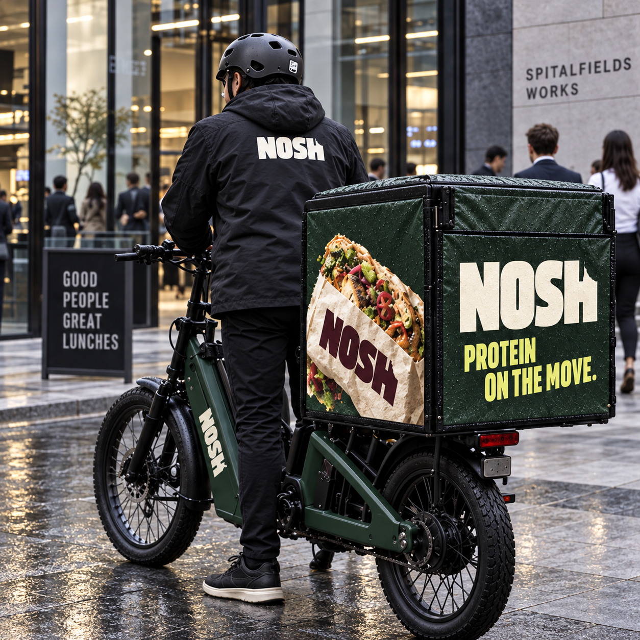 Nosh-branded delivery courier on a cargo e-bike outside Spitalfields Works